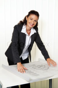 Architect with blueprint in the office. Plans of a house are processed